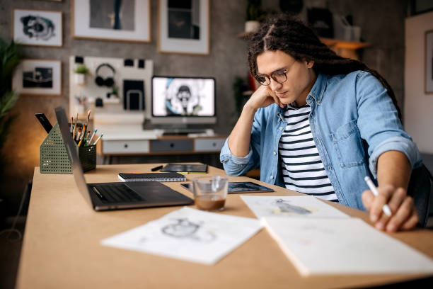 istock Handsome graphic designer designing at his home office 1363771331