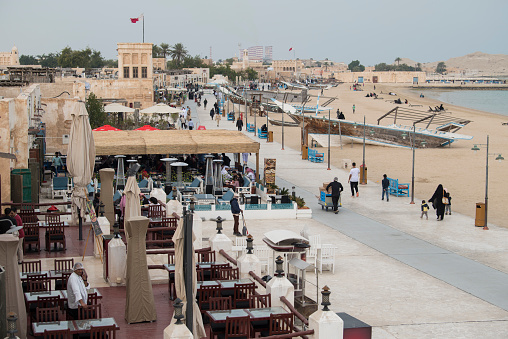 Al Wakrah ,Qatar -02,01,2020  : New souk waterfront promenade with his traditional houses and local people enjoying walking