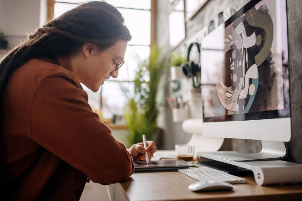 istock Young casually clothed graphic designer working from his home office 1363772685