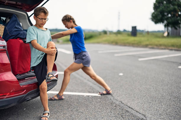 Kids stretching during the road trip stop stock photo