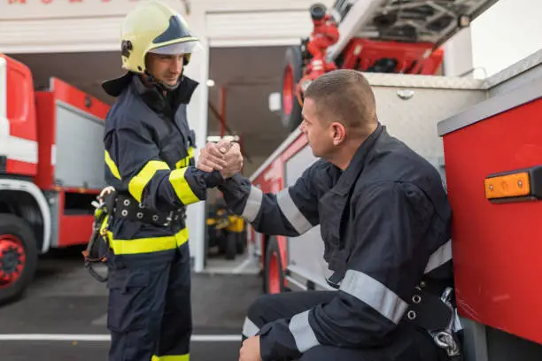 Photo of Fireman greeting each other