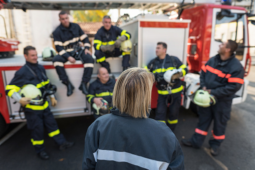 Group of firefighters putting hands together