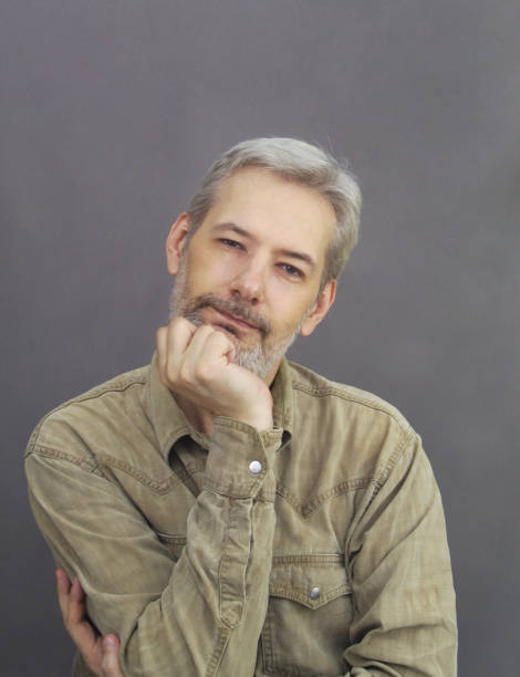 istock Satisfied middle age men with silver hair and beard looking at camera 1363781546