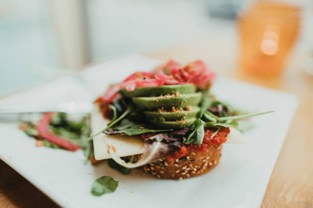 istock Avocado toast with vegan cheese for breakfast in a restaurant 1363787922
