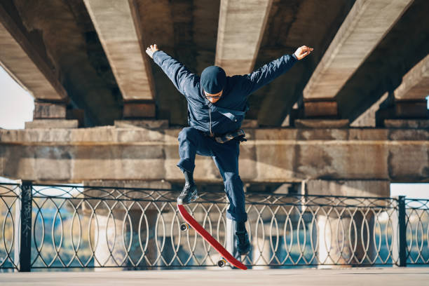 istock Skateboarder doing a trick on the street urban background 1363789070