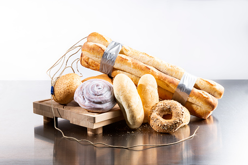 A gluten intolerance still life concept. Baguettes made into a stick of dynamite with a detonating cord to convey the effects gluten has on celiac disease which is an immune system condition.