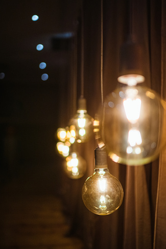 Round Electrical LED bulbs hanging in a row