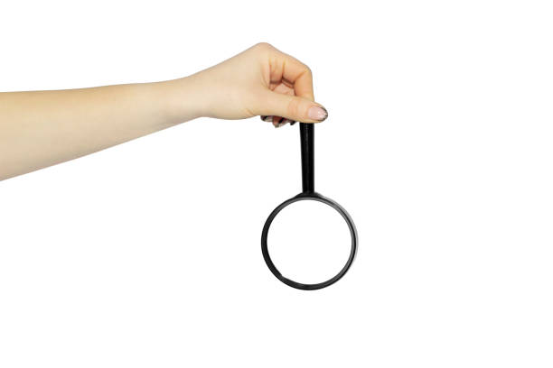 magnifying glass, lens in hand on white background, concept to pass or throw away - magnifying glass lens holding europe imagens e fotografias de stock