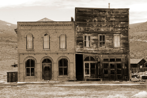 Two rectangular buildings in Bodie, California; a ghost town in the foothills of the eastern Sierra Mountain range.