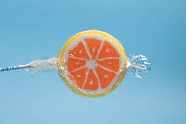 istock orange lollipop in wrapping 136379566