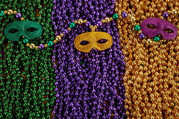 istock Mardi Gras Mask and colorful Mardi Gras Beads Background 1363796486