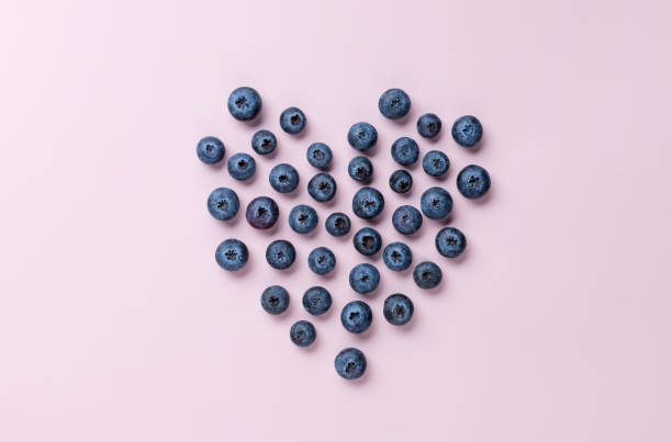 istock Heart shaped blueberries on color background 1363796493