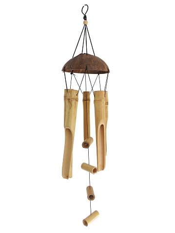 Bamboo wind chime isolated. Mobile chime wind pendant handmade on white background. Oriental style wood wind chime. Home and garden decoration. Relaxing music concept.