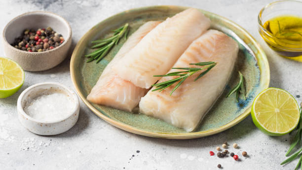 istock Raw fresh cod loin fillet steak with aromatic herbs, spices 1363796757