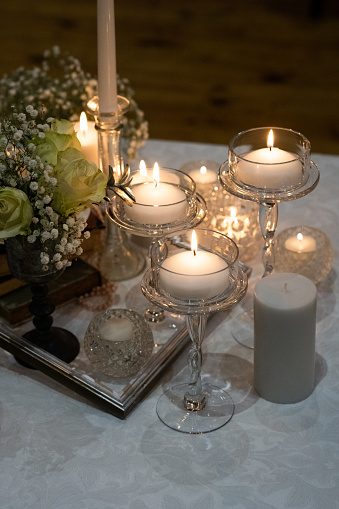 Indoor Wedding Decor Details of the Reception Tables with candles and flowers