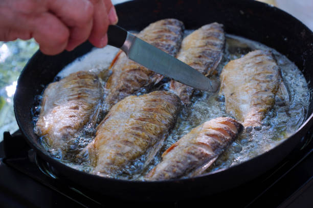 istock Small river fish is fried on a hike or fishing in camp pan 1363797832