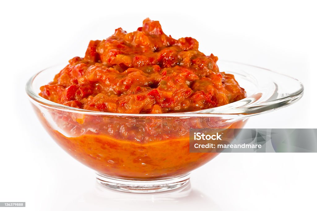 Glass bowl with ajvar Transparent glass bowl full of delicious ajvar, on a white background. Ajvar Stock Photo