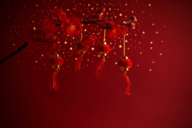 Chinese New Year background with sakura branch and lanterns.