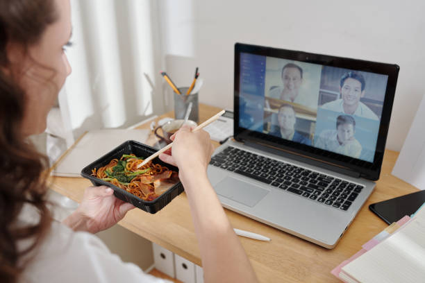 istock Woman Eating Lunch During Meeting 1363799781