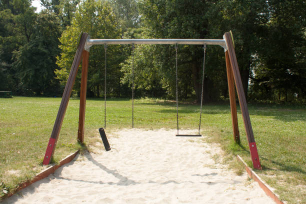 сломанные качели - swing playground empty abandoned стоковые фото и изображения