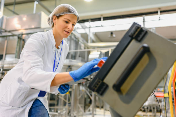 istock Female engineer working on maintenance in bottling plant 1363804786