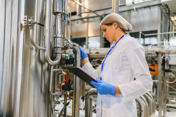 istock Female engineer working on maintenance in bottling plant 1363806318