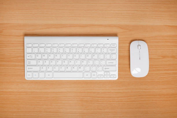 istock Keyboard and mouse on wooden table. top view. 1363806368