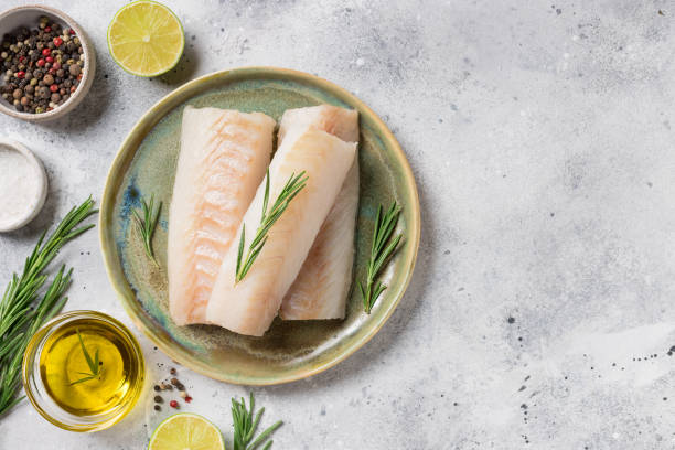 istock Raw cod loin fillet steak with aromatic herbs, spices, oil 1363806535