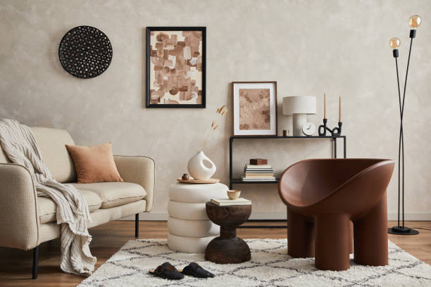 Modern composition of elegant living room interior design with mock up poster frame, sofa, armchair, pouf, console, coffee table, plants and stylish personal accessories. Copy space. Template.