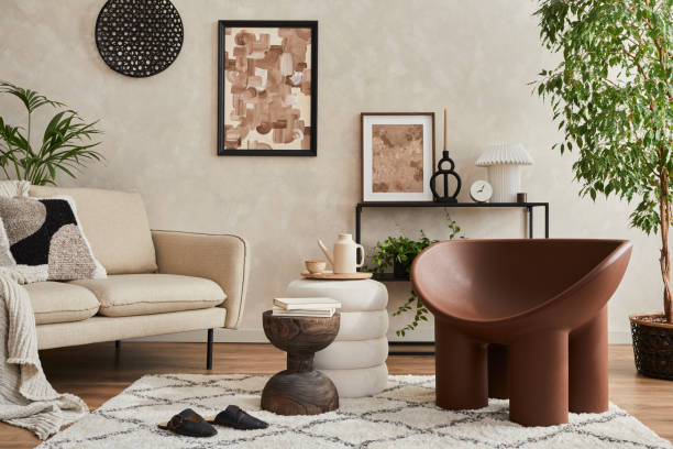 istock Modern composition of elegant living room interior design with mock up poster frame, sofa, armchair, pouf, console, coffee table, plants and stylish personal accessories. Copy space. Template. 1363806793