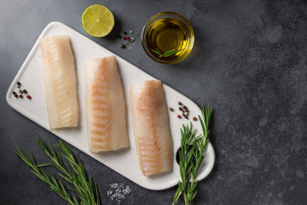 istock Raw cod loin fillet steak with ingredients for cooking 1363806796