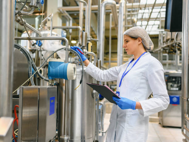 istock Female engineer working on maintenance in bottling plant 1363806970