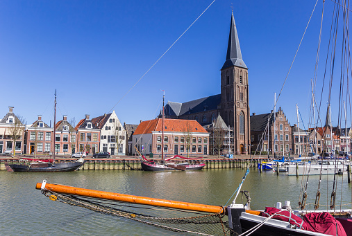 Bow of a sailing ship and church tower in Harlingen, Netherlands