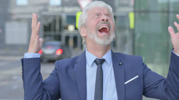 istock Old Businessman Screaming, Getting Crazy while Standing Outdoor 1363810049