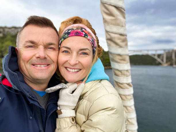 istock Happy couple taking selfie at sailboat bow during sailing 1363815104
