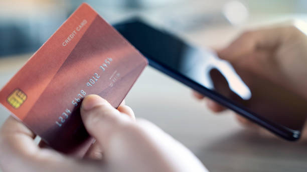 istock Paying with credit card on mobile phone 1363815155