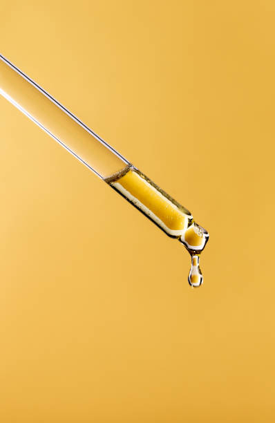 istock serum pipette close-up with falling drop on golden background 1363818681