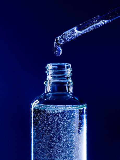 istock serum pipette with a falling drop on a dark background 1363818682