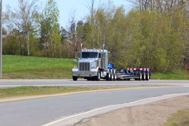istock Semi-truck and flat bed trailer 1363819507