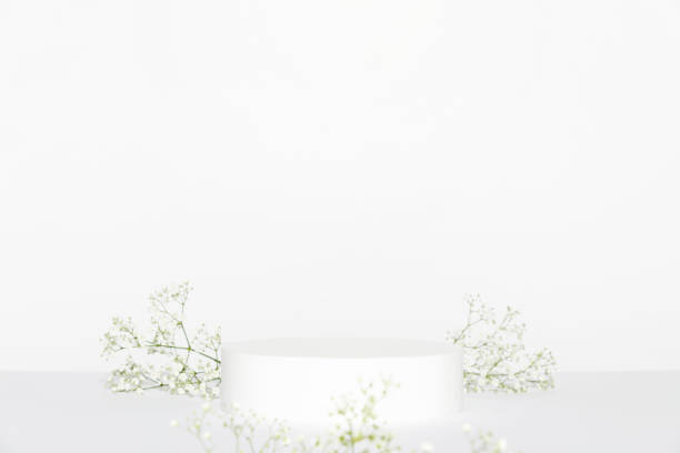 istock Abstract empty white podium and white flowers on grey background. Mock up stand for product presentation. 3D Render. Minimal concept. 1363823204