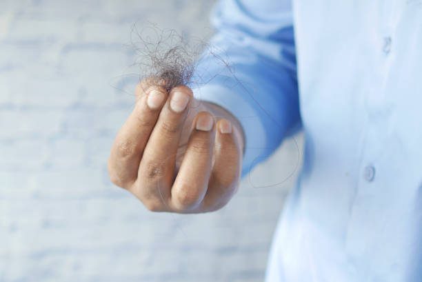 istock man hold his list hair close up 1363825352