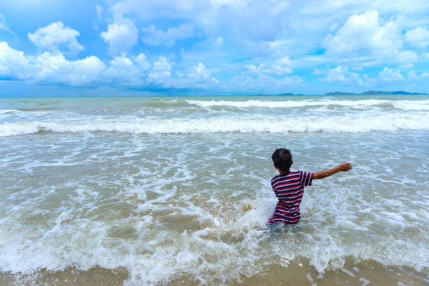 istock Asian kid play in the sea 1363826847