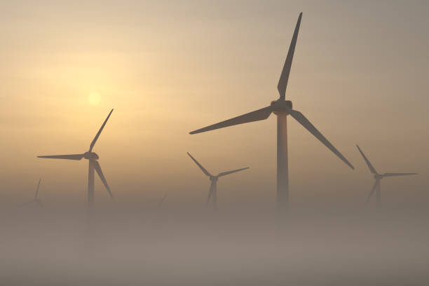 istock Wind turbines rise from thick fog 1363826886