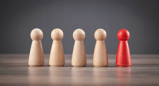 istock Wooden human figures on the desk. Leader 1363827525