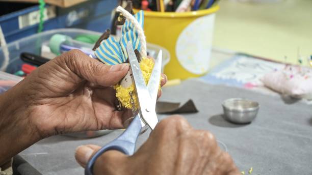 istock Artisan lady handcrafting a cloth doll 1363831775