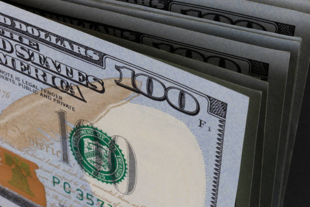 istock One Hundred Dollar bills stacked in a line - 100 Dollar bank notes in a stack. (Narrow depth of field) 1363831898