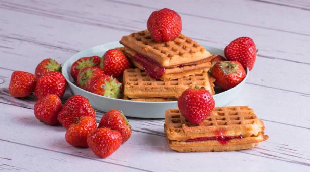 istock Vienna waffle muffins with strawberries and jam on a plate, side view, copy space 1363832248