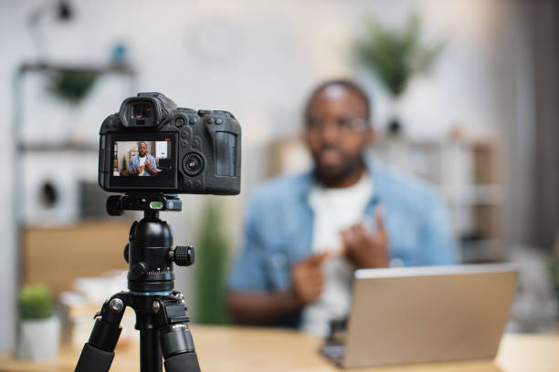 istock African guy recording new video blog on digital camera 1363832323