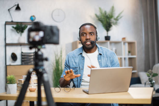 istock African american man in headset recording video on camera 1363832400