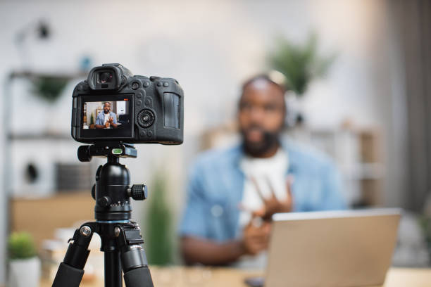 istock African american man in headset recording video on camera 1363832407